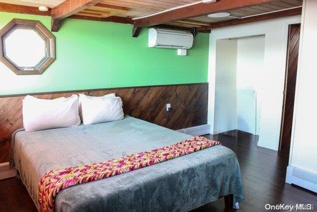 bedroom featuring wood walls, wooden ceiling, dark hardwood / wood-style floors, a wall mounted AC, and beam ceiling