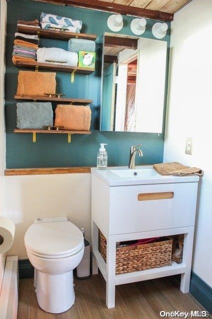 bathroom with vanity, hardwood / wood-style flooring, toilet, and wood ceiling