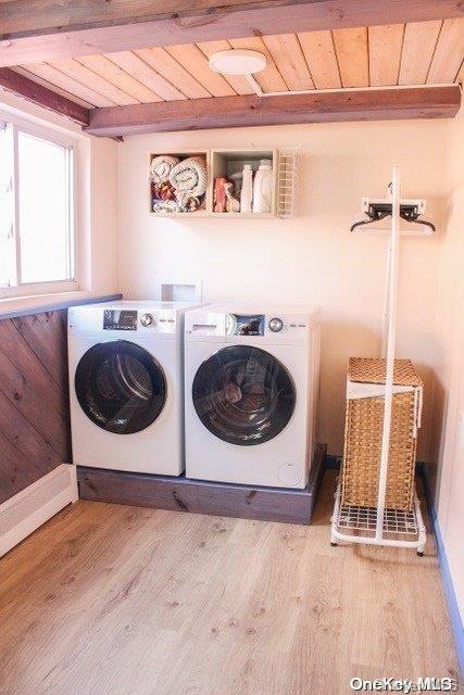 washroom featuring wooden ceiling, washer and clothes dryer, and light hardwood / wood-style floors