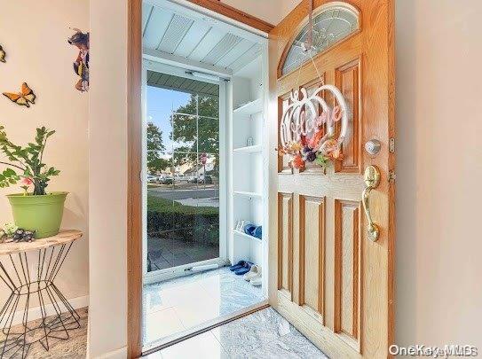 doorway to outside with beamed ceiling and wooden ceiling