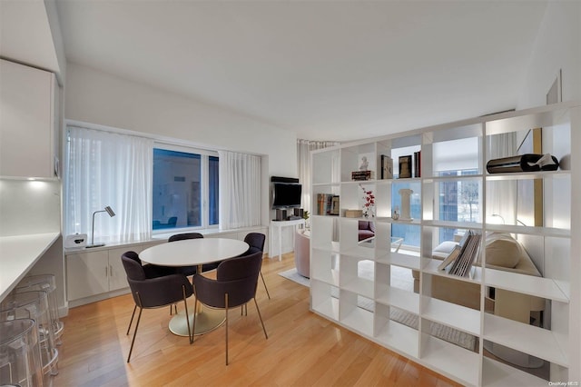 dining space with light hardwood / wood-style floors