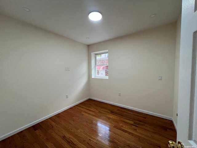 empty room featuring dark hardwood / wood-style flooring