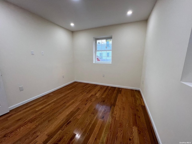 empty room with dark hardwood / wood-style flooring