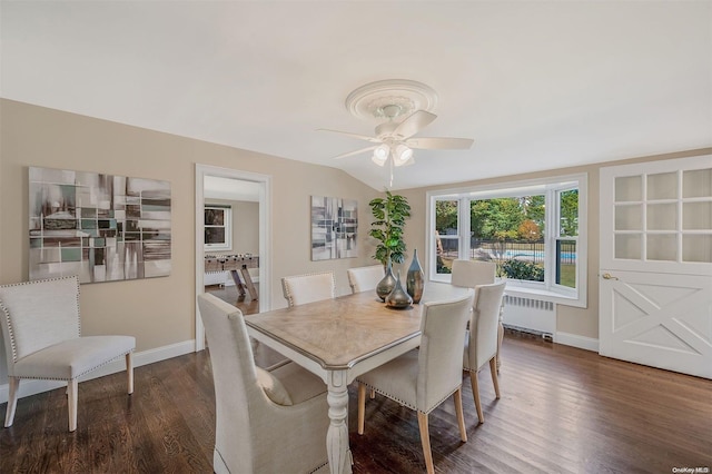 dining room featuring ceiling fan, radiator heating unit, dark wood-type flooring, and vaulted ceiling