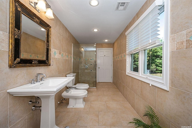 bathroom with a bidet, a shower with door, toilet, and tile walls