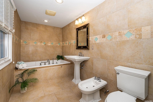 bathroom featuring a bidet, a relaxing tiled tub, tile walls, and toilet