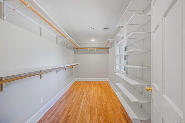 spacious closet featuring hardwood / wood-style flooring