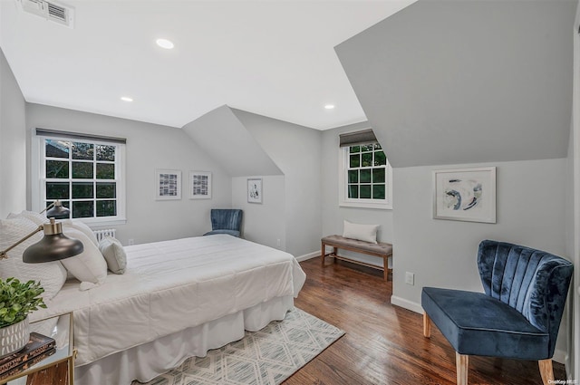 bedroom with dark hardwood / wood-style floors and lofted ceiling