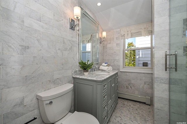 bathroom featuring vanity, a baseboard heating unit, toilet, tile walls, and walk in shower