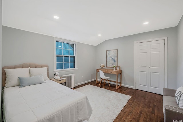 bedroom featuring dark hardwood / wood-style floors, radiator, and vaulted ceiling