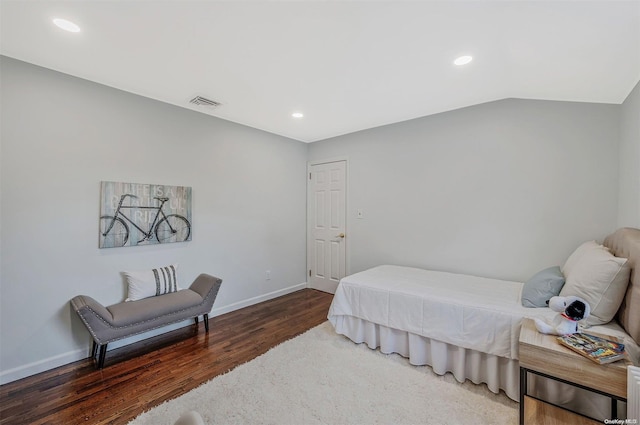 bedroom with dark hardwood / wood-style floors and vaulted ceiling