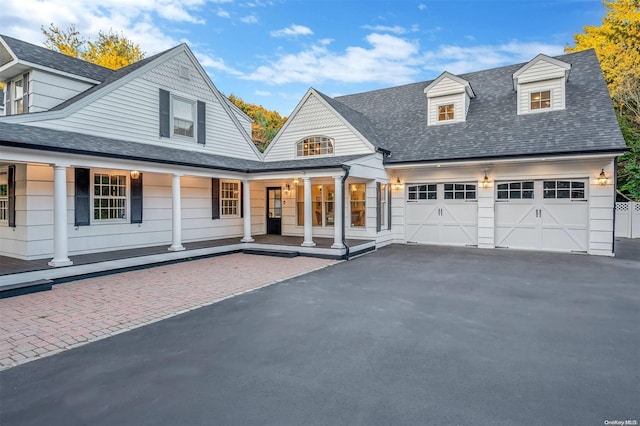 view of front facade featuring covered porch and a garage