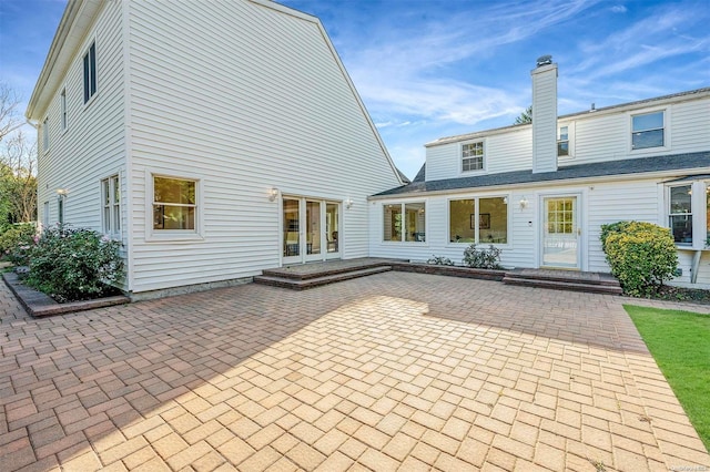 back of property featuring french doors and a patio area