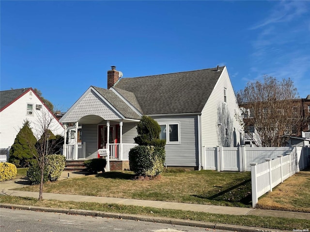 view of front of home featuring covered porch and a front lawn