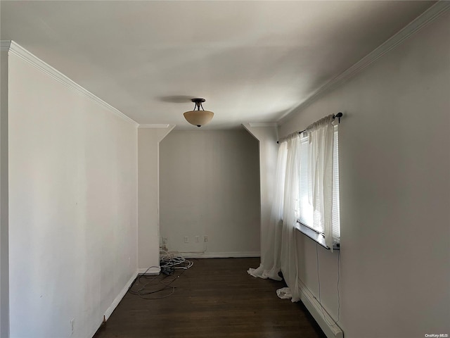 spare room featuring dark hardwood / wood-style floors and ornamental molding