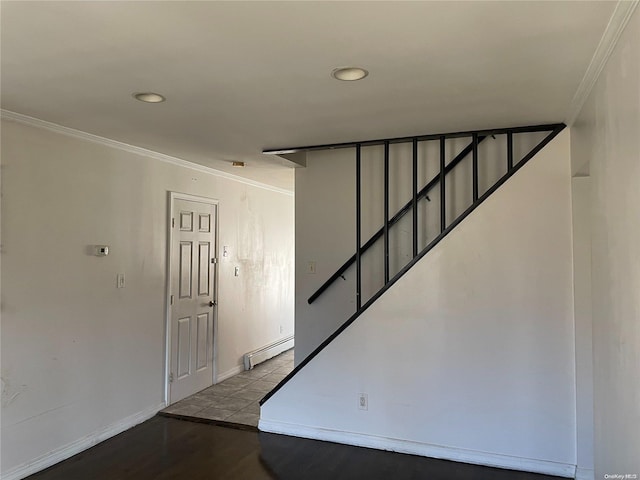 stairs with baseboard heating, ornamental molding, and hardwood / wood-style flooring