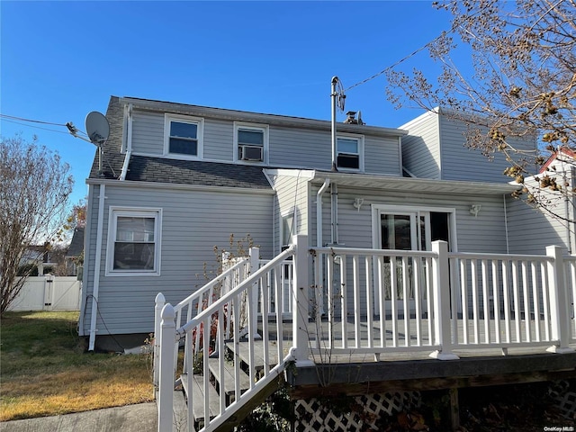 rear view of house featuring a wooden deck