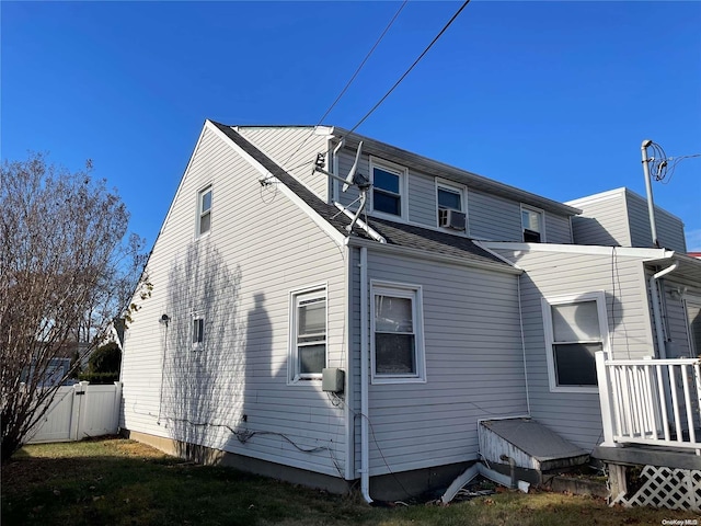 rear view of house featuring cooling unit