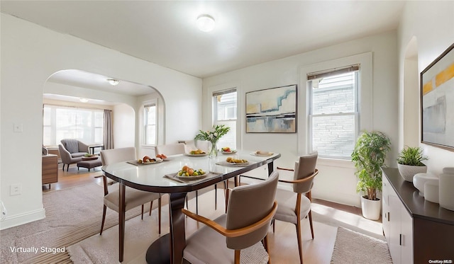 dining space with plenty of natural light and light hardwood / wood-style flooring