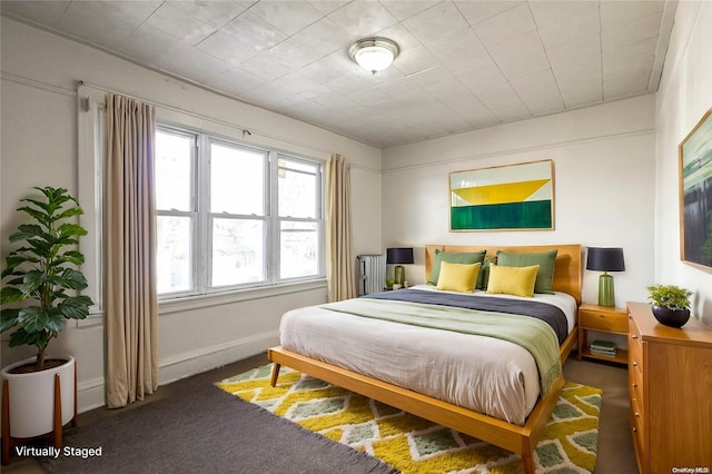 bedroom featuring dark colored carpet