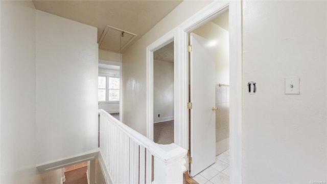 hall with light tile patterned floors