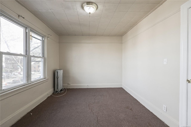 unfurnished room with carpet floors and radiator