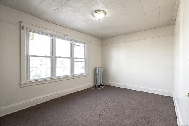 empty room featuring carpet and radiator