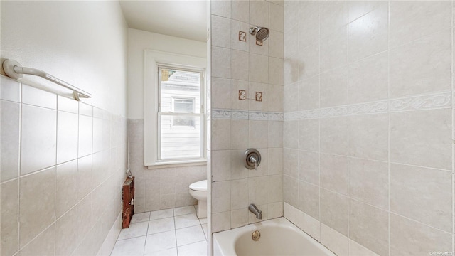 bathroom featuring a wealth of natural light, tile patterned flooring, tiled shower / bath combo, and toilet