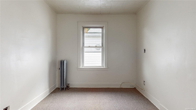 carpeted spare room with radiator