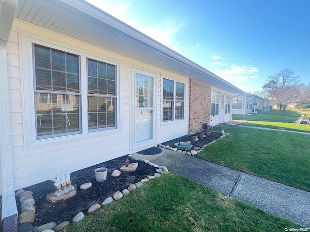 view of side of home with a yard