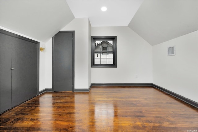 bonus room featuring dark hardwood / wood-style flooring and lofted ceiling