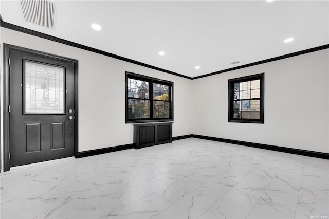 foyer with crown molding and a wealth of natural light