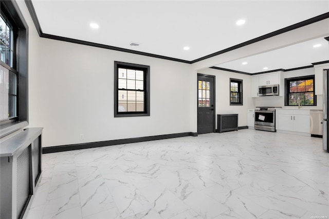 unfurnished living room featuring ornamental molding