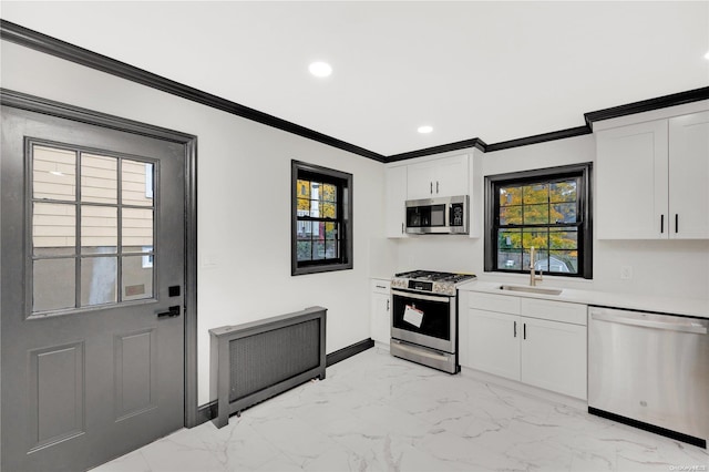 kitchen with white cabinets, a wealth of natural light, sink, and appliances with stainless steel finishes