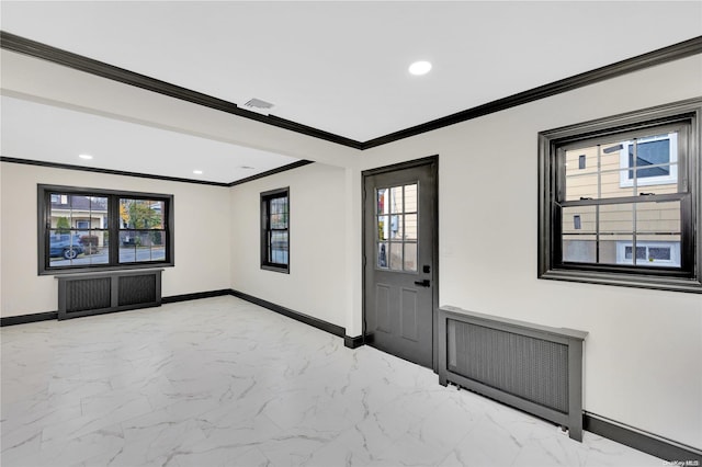 foyer entrance with radiator heating unit and ornamental molding