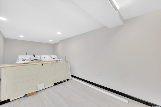 laundry area featuring washer and dryer and light wood-type flooring