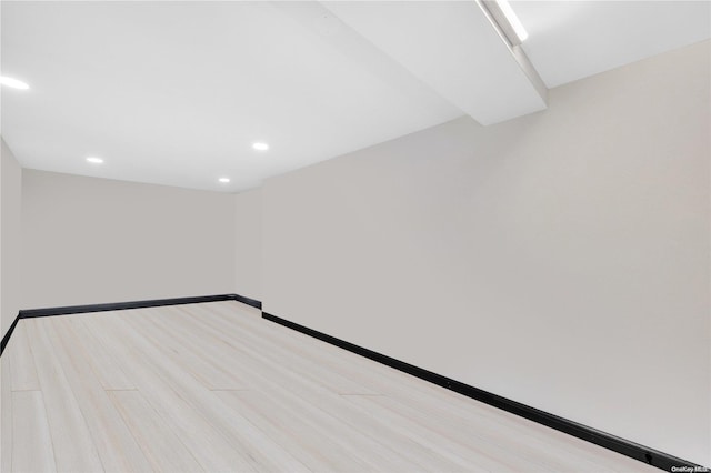 empty room with light hardwood / wood-style flooring