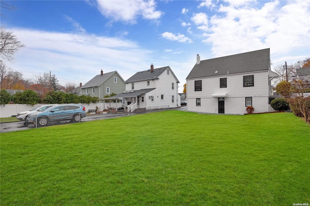 back of house with a lawn