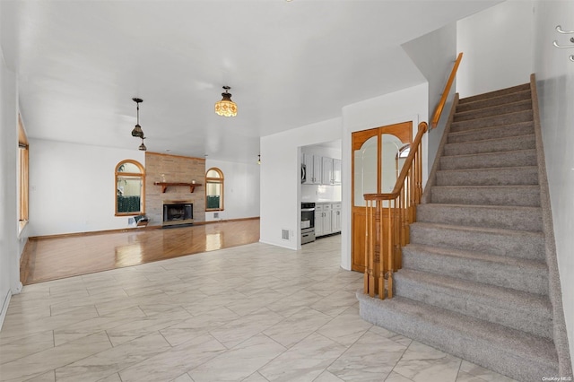 staircase featuring a fireplace