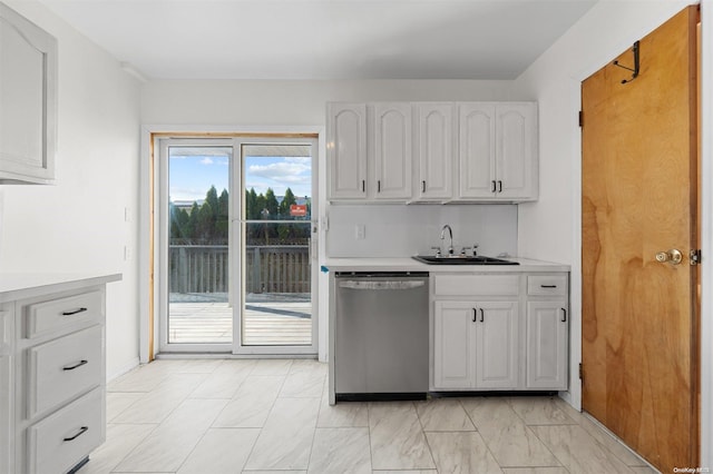 kitchen with white cabinets, dishwasher, and sink