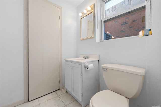 bathroom featuring tile patterned flooring, vanity, and toilet