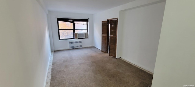 hall with carpet flooring and radiator heating unit