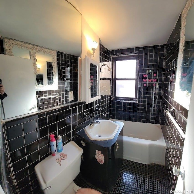 full bathroom featuring tiled shower / bath combo, sink, tile walls, tile patterned flooring, and toilet