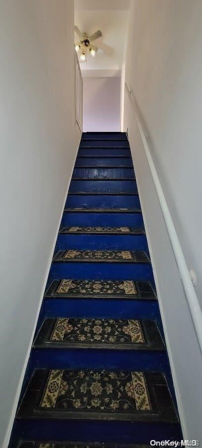 stairway with ceiling fan