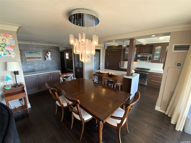 dining space with crown molding, dark wood-type flooring, and an inviting chandelier