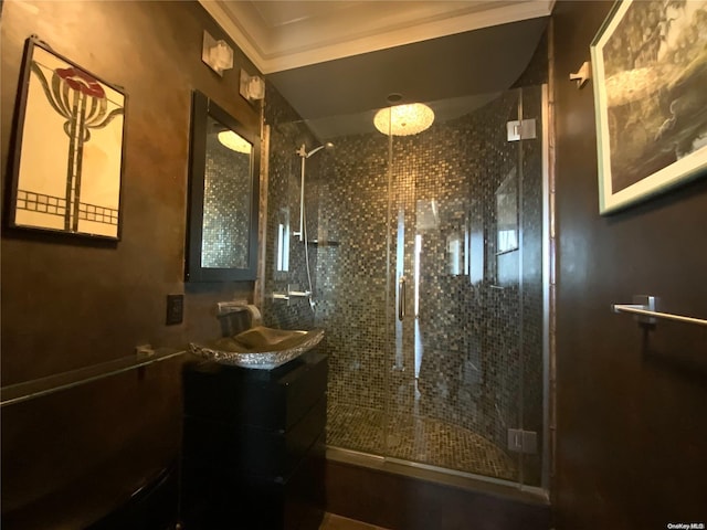 bathroom featuring tiled shower and vanity