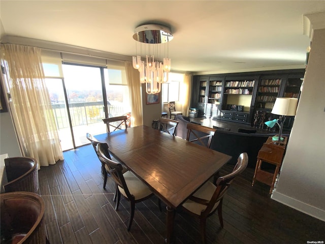 dining room with dark hardwood / wood-style floors and a notable chandelier