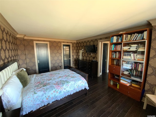 bedroom featuring crown molding and dark hardwood / wood-style floors