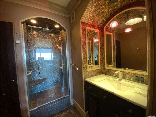 bathroom featuring tasteful backsplash, vanity, and an enclosed shower