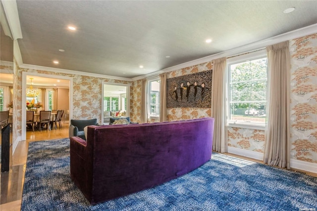 living room featuring hardwood / wood-style floors, a textured ceiling, a wealth of natural light, and ornamental molding